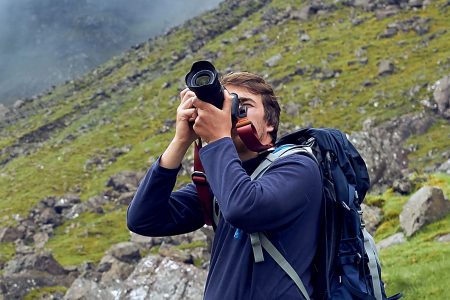 Man taking photos of Scottish scenery