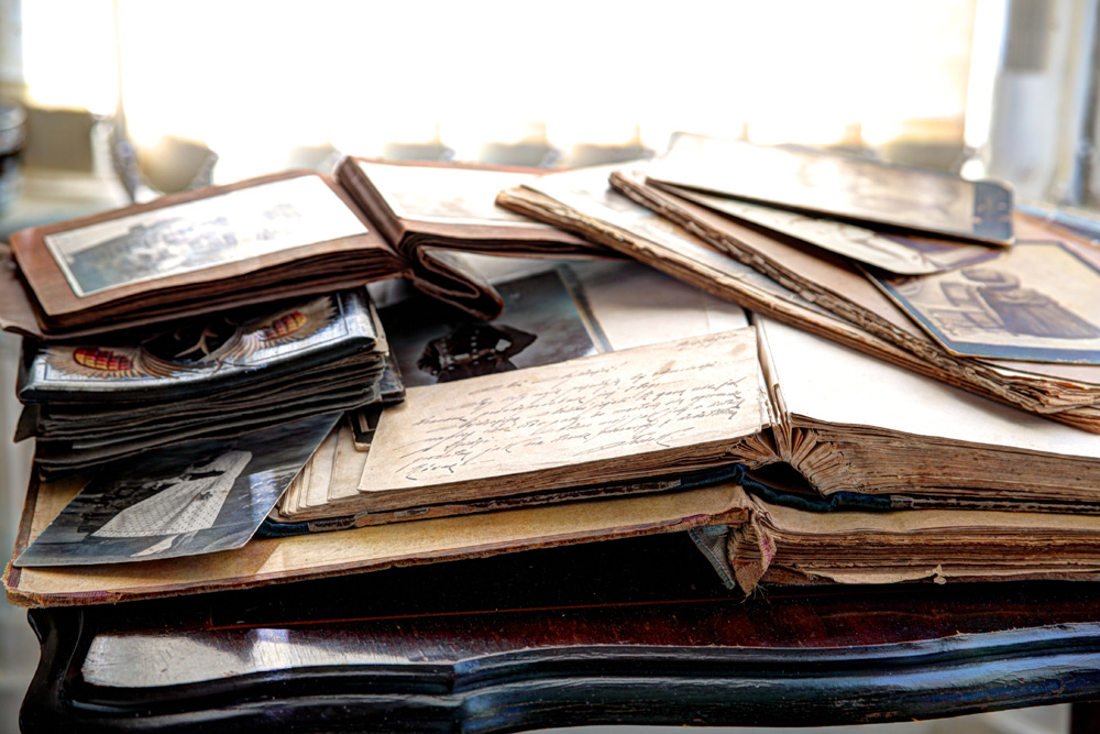 Old books, albums and photos on antique table