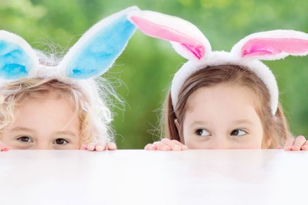 Two children wearing bunny ears at an Easter event