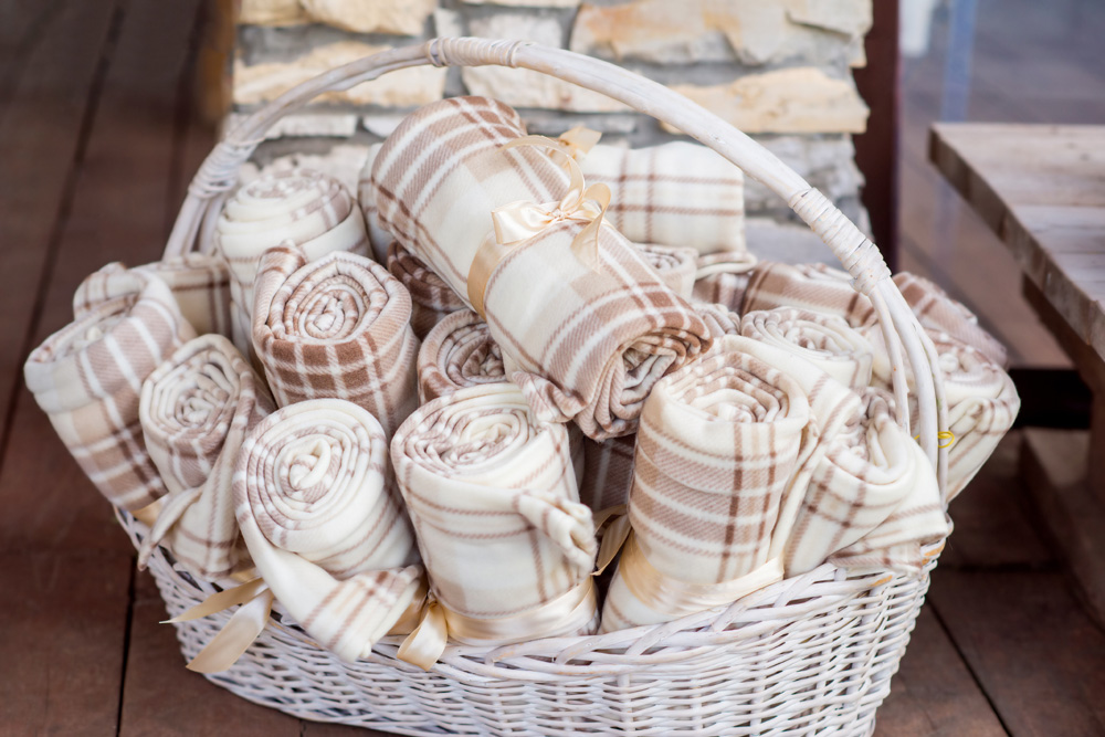 A basket filled with rolled winter blankets