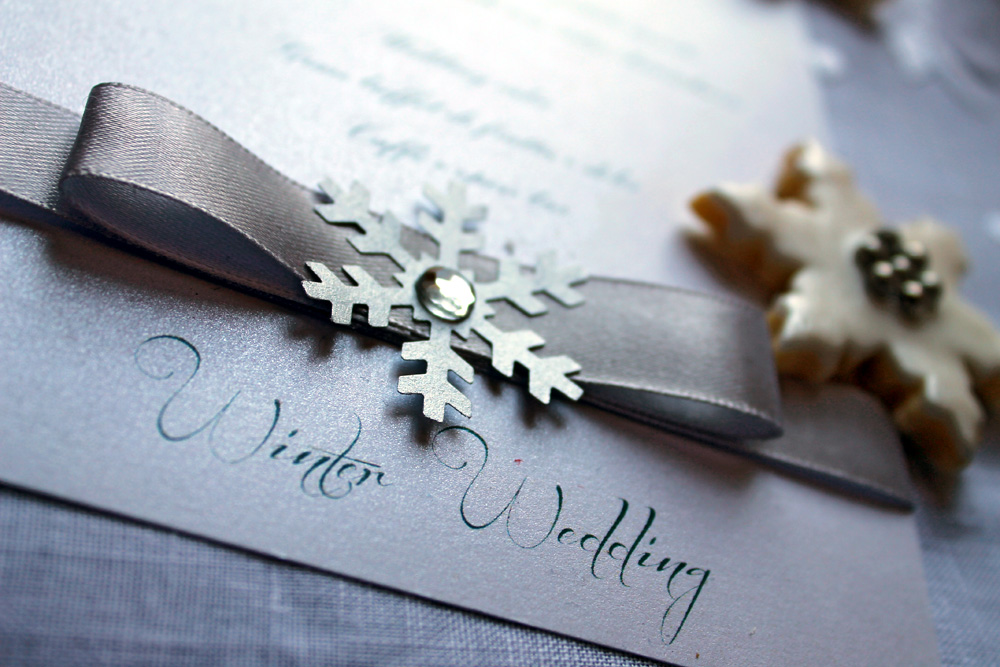 A winter wedding invitation with snowflake detail