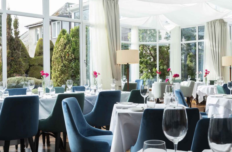 The Conservatory restaurant with tables set for dining in the Kingmills Hotel