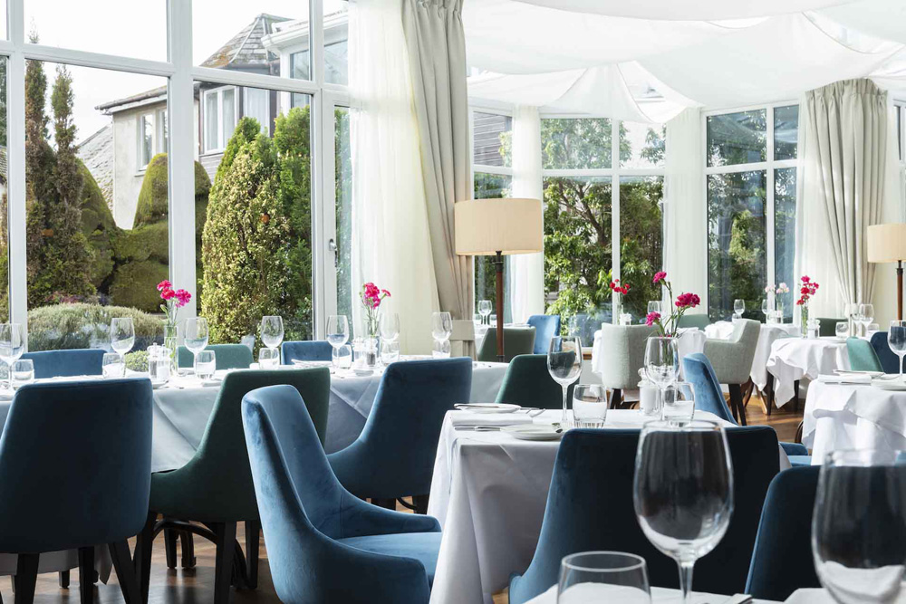 The Conservatory restaurant with tables set for dining in the Kingmills Hotel