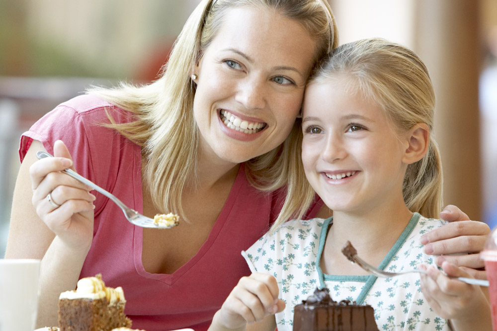 Mother and daughter smiling for photo in restaurant