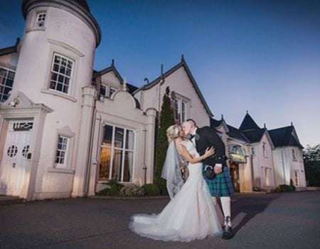 A bride and groom outside the Kingsmills Hotel