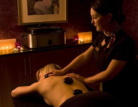A girl having a hot stone massage at the Kingsmills Hotel in Inverness