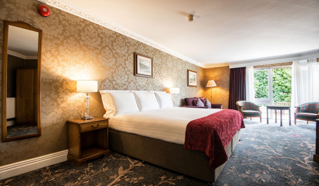 A beautiful room with bed and sofa at Kingsmills Hotel, Inverness