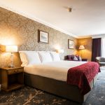A beautiful room with bed and sofa at Kingsmills Hotel, Inverness
