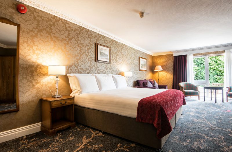 A beautiful room with bed and sofa at Kingsmills Hotel, Inverness