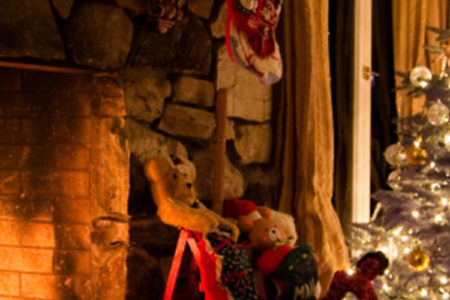A roaring fire with a Christmas tree next to it