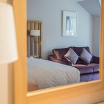 A reflection of a sofa with pillows in a luxury room at Kingsmills Hotel, Inverness