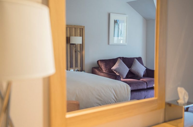 A reflection of a sofa with pillows in a luxury room at Kingsmills Hotel, Inverness