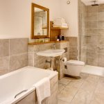 A bathroom suite with bath and shower in a Luxury Family Room in Kingsmills Hotel