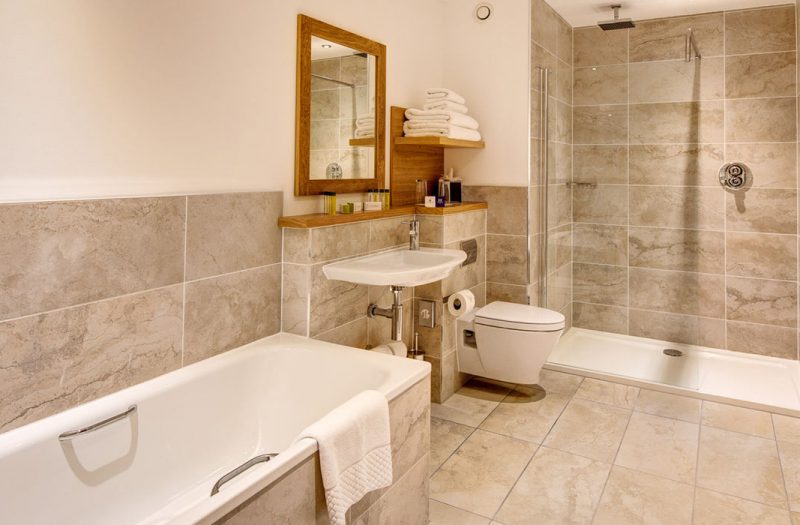 A bathroom suite with bath and shower in a Luxury Family Room in Kingsmills Hotel