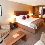 Living area and large double bed in a Retreat Family Room at Kingsmills Hotel