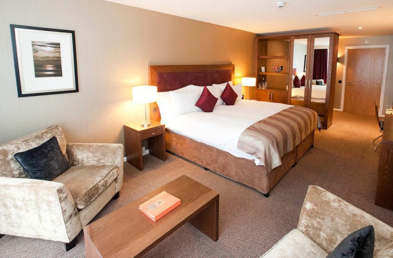 Living area and large double bed in a Retreat Family Room at Kingsmills Hotel