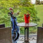 A balcony with a golf course in the background in a Retreat Room at Kingsmills Hotel