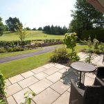 A patio and garden furniture outside a Retreat room at Kingsmills Hotel