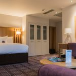 A luxury family room with bed and sofa at Kingsmills Hotel, Inverness