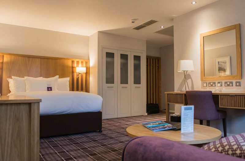 A luxury family room with bed and sofa at Kingsmills Hotel, Inverness