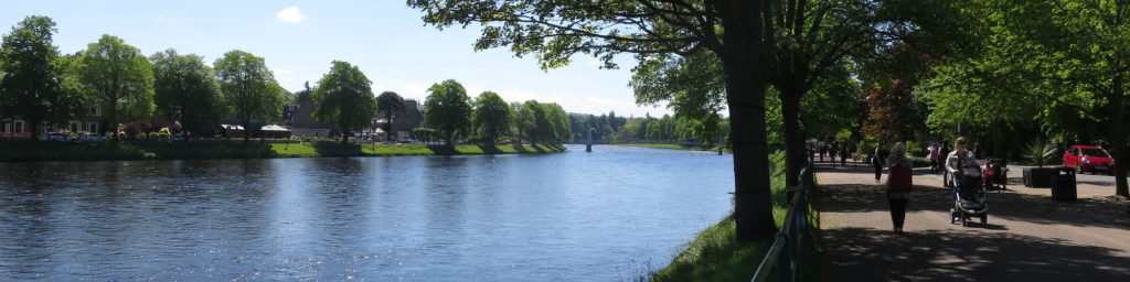 People walking along the banks of the River Ness