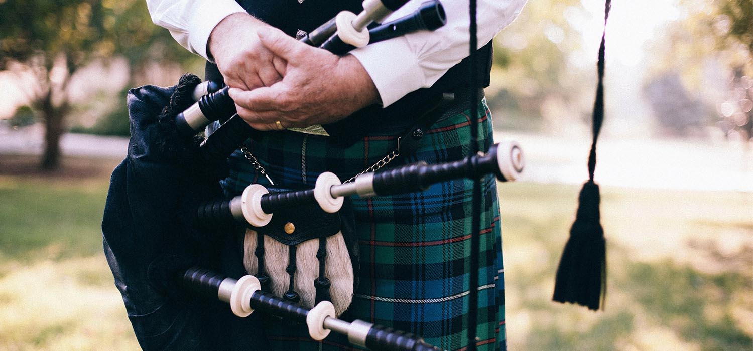 Bagpipe player holding bagpipes