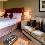 The Cocoon Room with bed and sofa at Kingsmills Hotel, Inverness