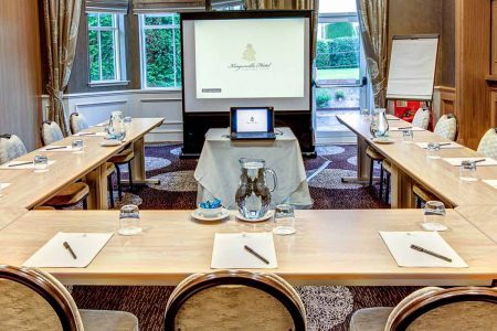 A room at Kingsmills Hotel, Inverness, set up for a small meeting or conference with a projection screen.