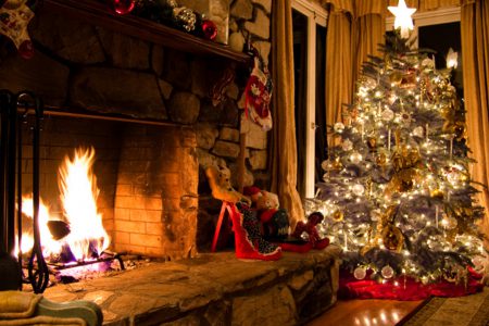 A festive winter getaway with Christmas tree and fire.