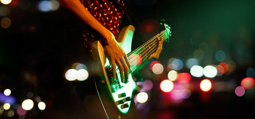 A person on stage playing a guitar