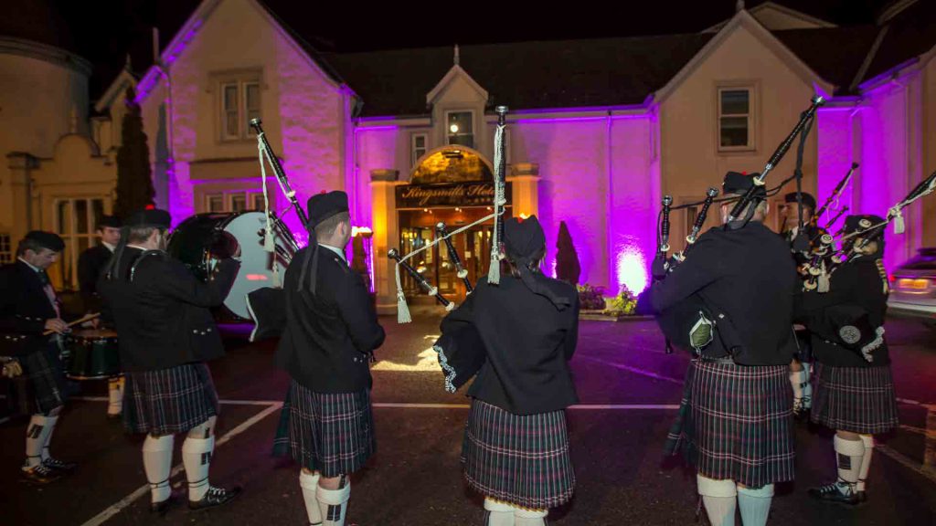 A pipeband outside the the Kingsmills Hotel, Inverness at night