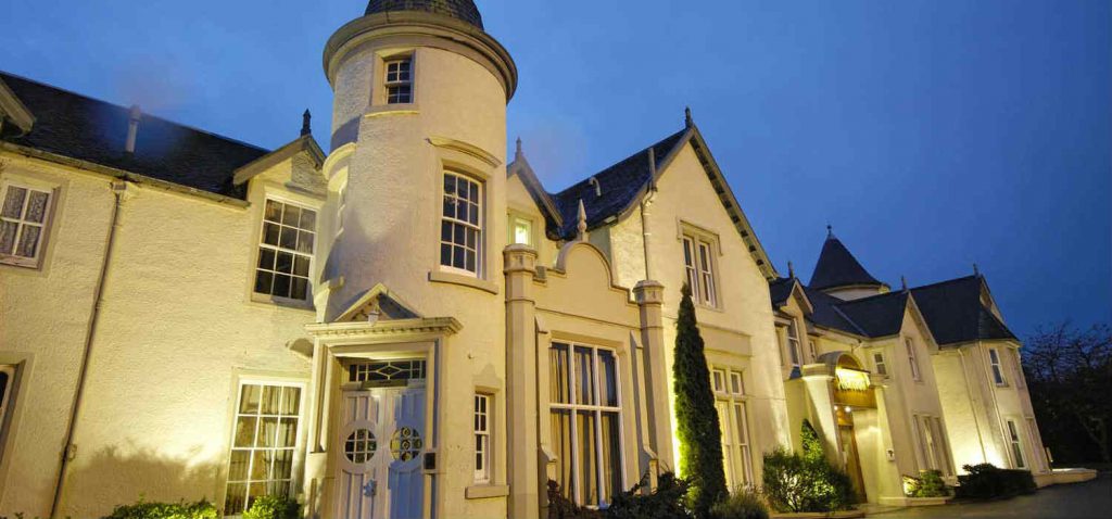 An outside view at night of the Kingsmills Hotel, Inverness