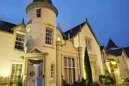 An outside view at night of the Kingsmills Hotel, Inverness