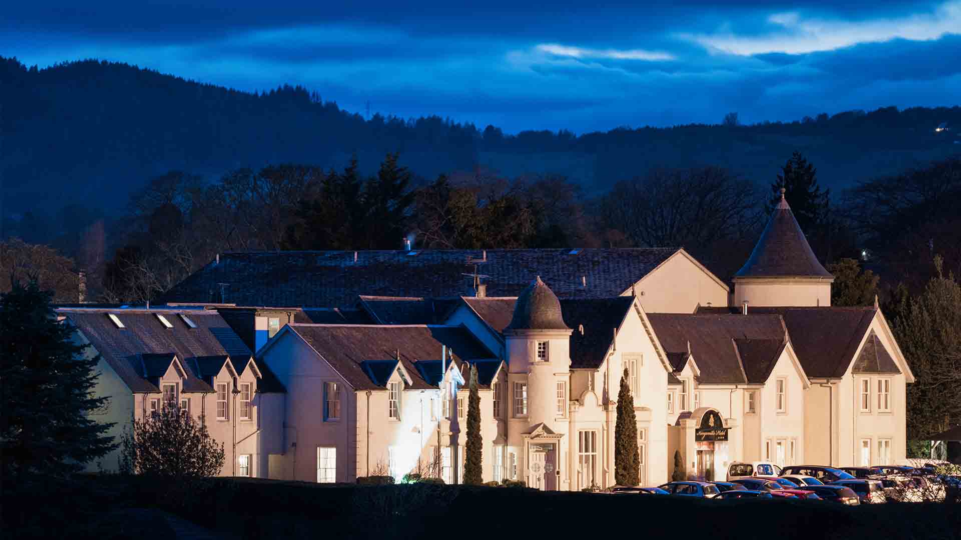 Exterior of Kingsmills hotel lit up at night