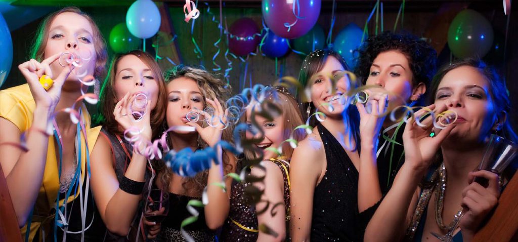 A group of ladies blowing streamers at a party night