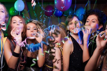 A group of ladies blowing streamers at a party night
