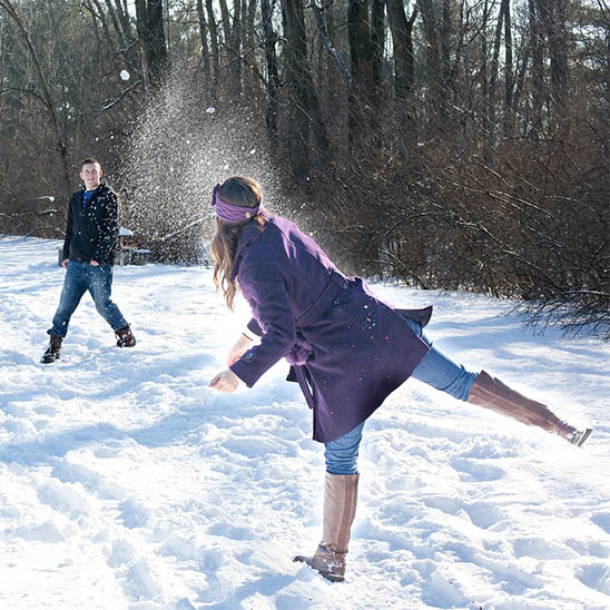 A couple having a snowball fight