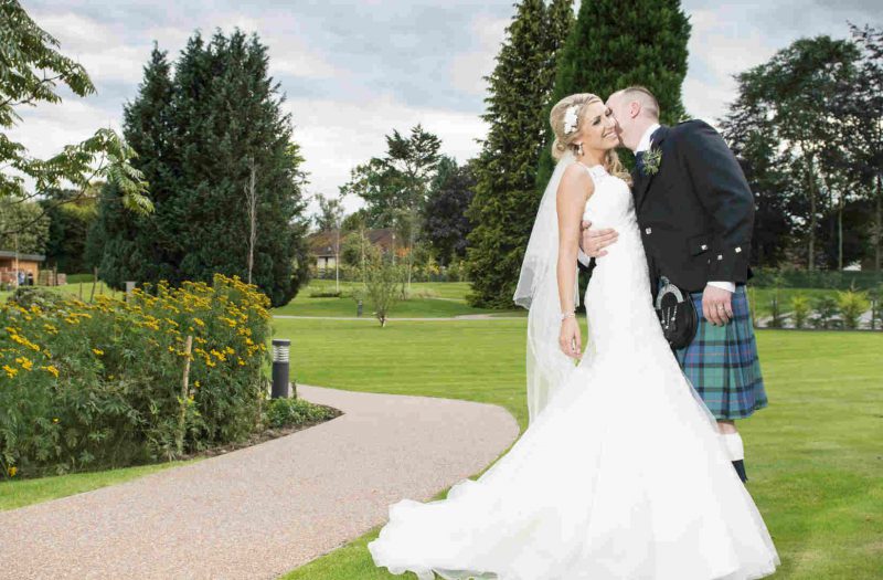 Weddings at the Kingsmills Hotel|Wedding Room at Kingsmills|Close up of iced flowers on a wedding cake|Close up of a bride bouquet|Bride and groom sharing a kiss outside Kingsmills Hotel in Inverness|Bride and groom walking through the gardens at Kingsmills Hotel|Bride and groom kissing the gardens at Kingsmills Hotel|Bride and Groom sharing an intimate moment on their wedding day|Bride & Groom in Kingsmills Hotel Gardens