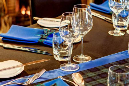 A table laid out in tartan ready for a business dinner