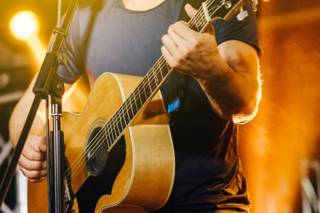 Man playing guitar at live music event