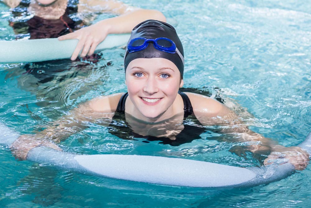 Adult woman learning to swim