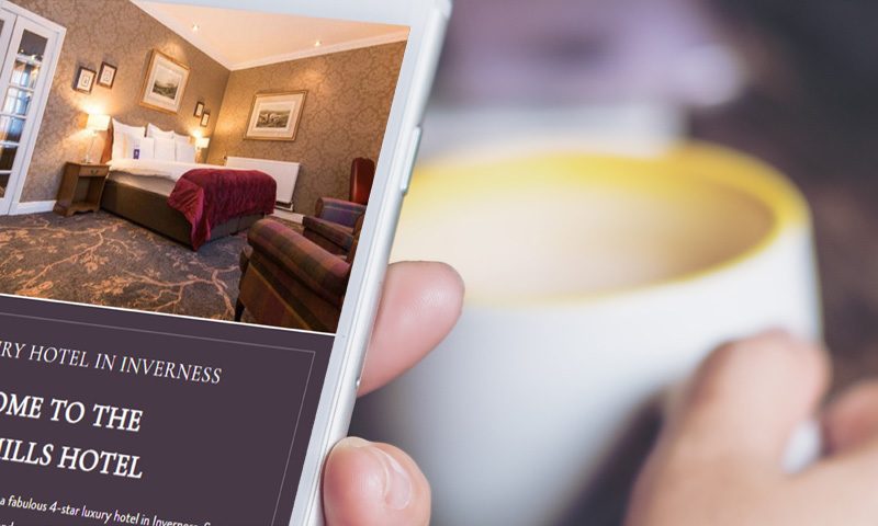Person on phone looking at Kingsmlls Hotel website