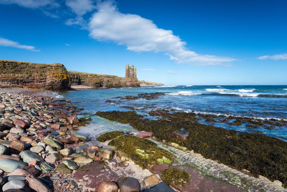 The ruins of Keiss Castle on cliffs at Caithness on the north east coast of Scotland