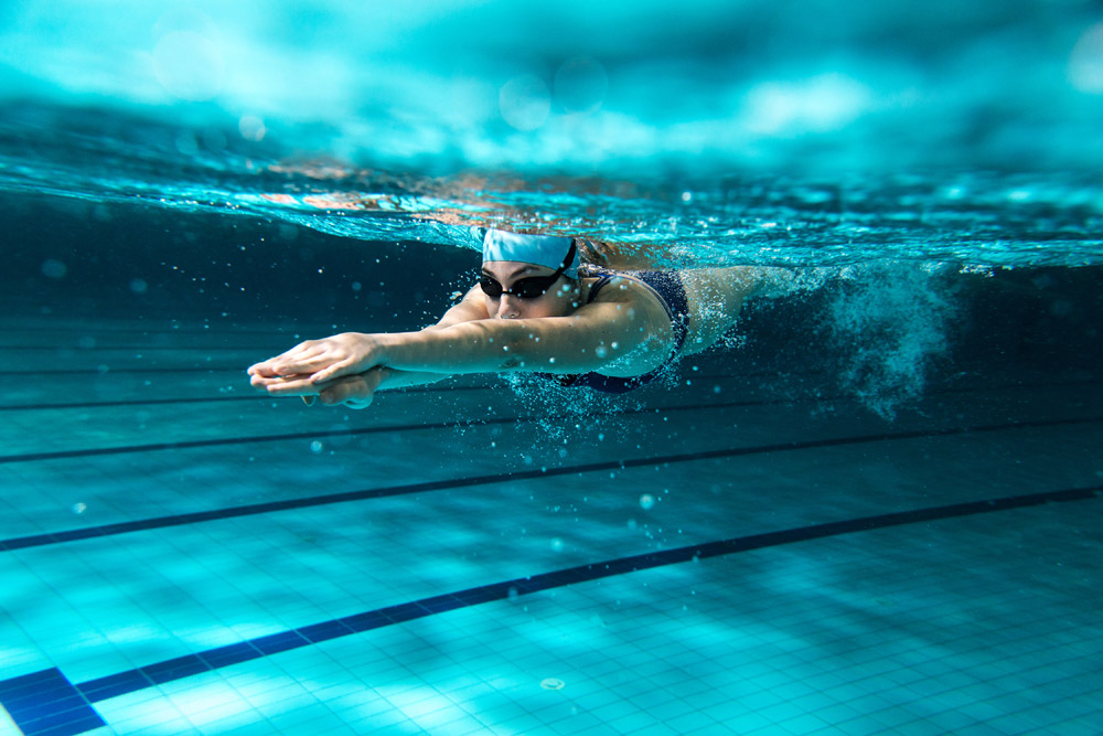 Woman swimming underwater in a pool