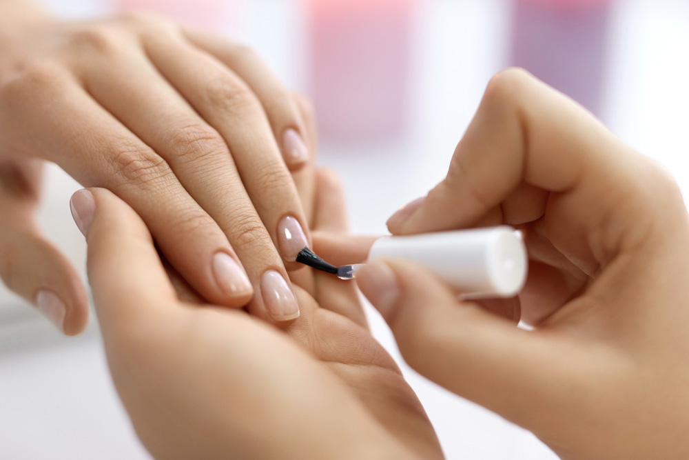 Woman having her nails painted