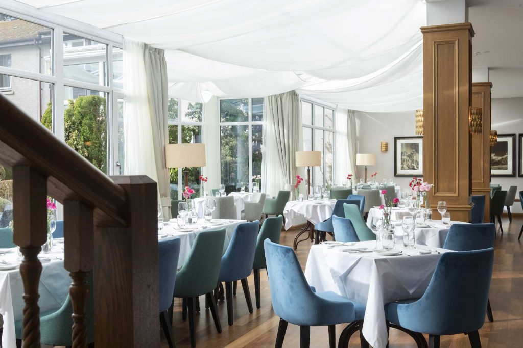 Restaurant filled with natural light and set for dinner service