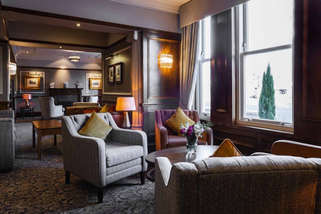 Armchairs by the window in the reception lounge in the Kingmills Hotel