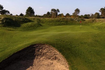 Nairn Dunbar Golf Green surrounded by sand bunkers