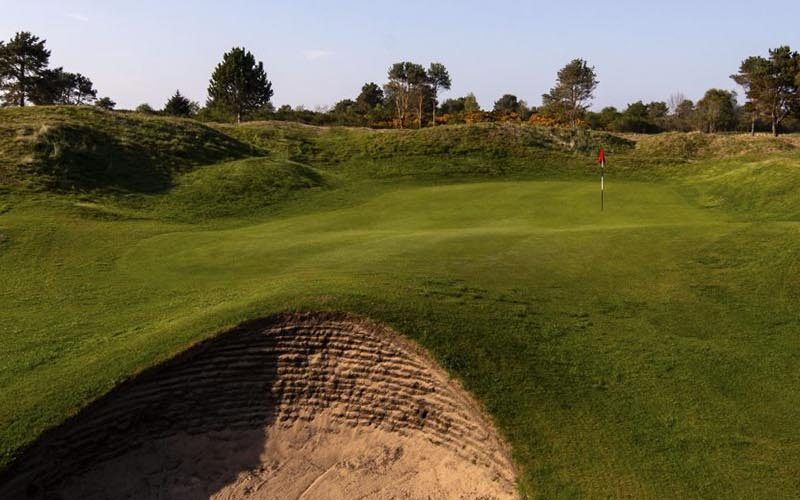 Nairn Dunbar Golf Green surrounded by sand bunkers