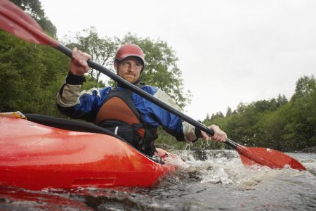 Man kayaking on river